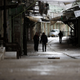 Palestinians walk down an empty street during a full strike in Hebron.